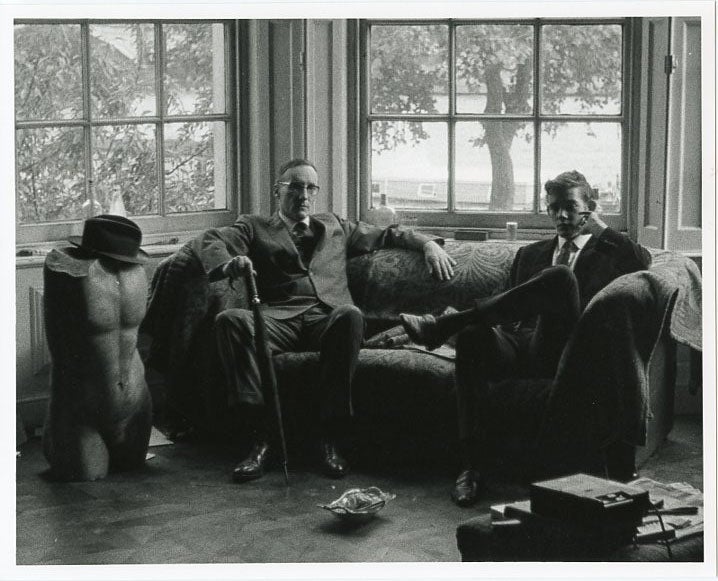 Item #SKB-377 An original b&w photograph (recent print) of William Burroughs and an unidentified young man sitting on a couch in front of a huge bay window in an English mansion. William S. BURROUGHS.