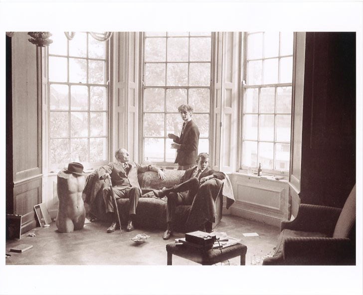 Item #SKB-379 An original b&w photograph (recent print) of William Burroughs and another man sitting on a couch in front of a huge bay window in an old English mansion. William S. BURROUGHS.