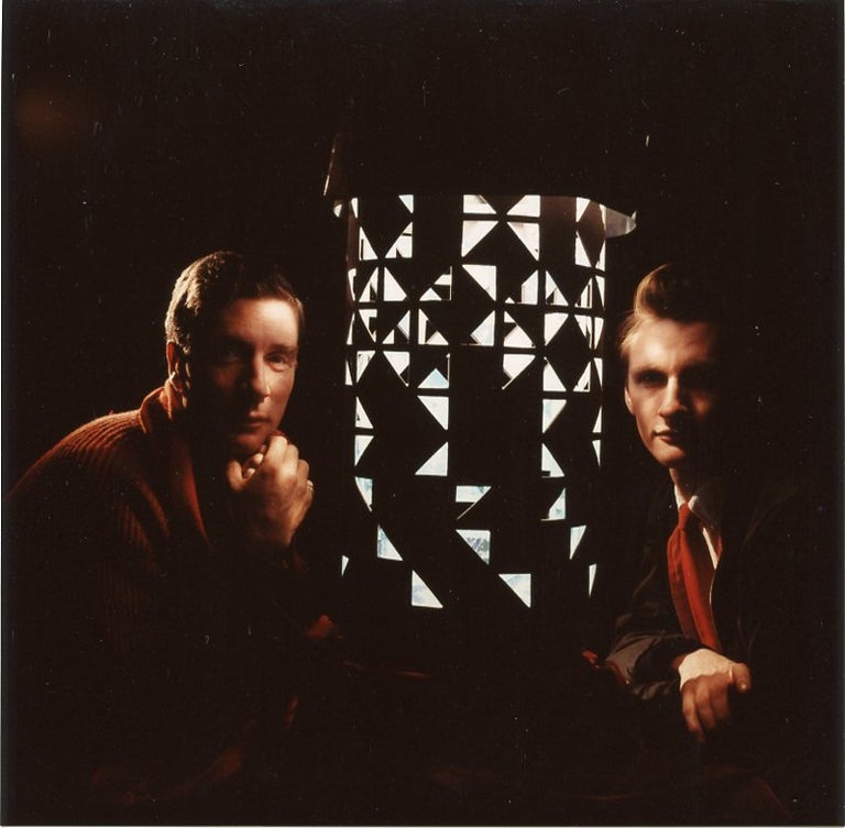 Item #SKB-3960 Color photograph (recent print) of Brion Gysin and Ian Sommerville sitting on either side of a dream machine, looking directly into the camera. Brion GYSIN, Herman LEONARD.